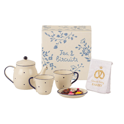 teapot cups plate with biscuits on, pastry paper bag and box