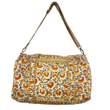 Floral patterned duffle bag with a strap on a white background