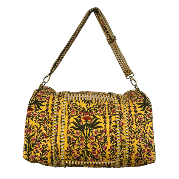Duffle bag with sweeping vine pattern on a yellow background