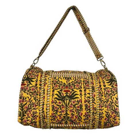 Duffle bag with sweeping vine pattern on a yellow background