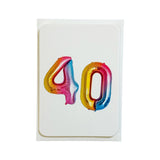 A white greeting card featuring the number 40 in metallic foil balloon-style lettering with a pink, yellow, and blue gradient, set against a plain white background.