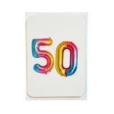 A white greeting card featuring the number '50' in metallic, foil-like balloons with a rainbow gradient of blue, pink, orange, and yellow, set against a plain white background.