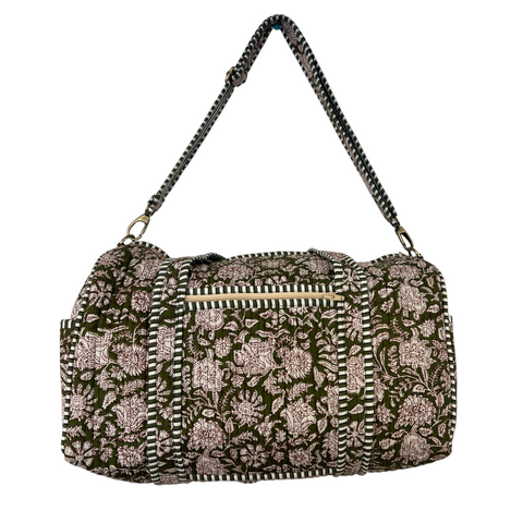 Duffle bag with green fabric and  white floral print.