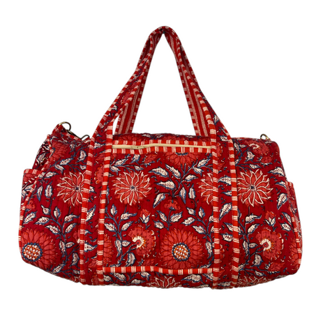 Red floral patterned duffle bag on a white background