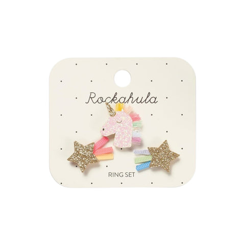 Ring set with unicorn and star designs on a white card.