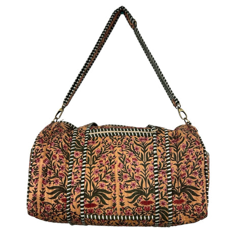 Floral patterned duffle bag with removable strap on a white background