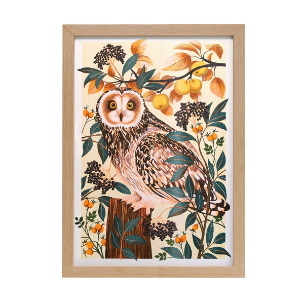 A print of an owl surrounded by branches 