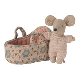 baby mouse next to fabric carry cot on a white background