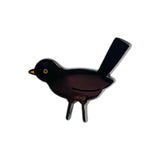 Black bird-shaped enamel pin  on a white background