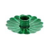 Green metal flower shaped candle holder on a white background
