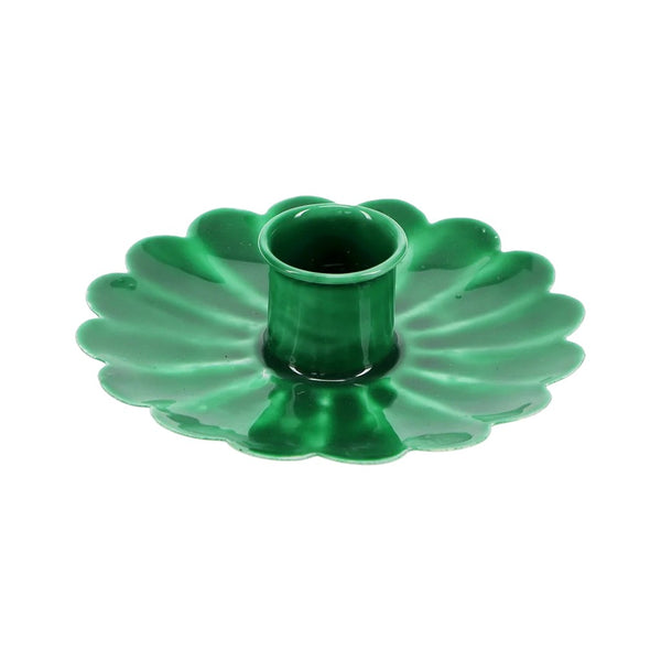 Green metal flower shaped candle holder on a white background