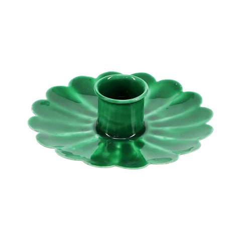 Green metal flower shaped candle holder on a white background