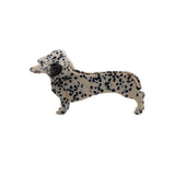 Sausage dog-shaped  clip claw with black spots on a white background