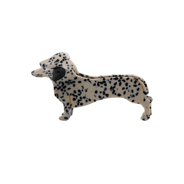 Sausage dog-shaped  clip claw with black spots on a white background