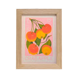 A framed art print featuring a vintage-style illustration of crab apples in autumn colors, set in a light natural wood frame against a white background.