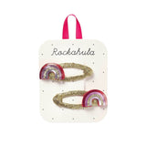 Packaged hair accessories with rainbow design on branded card.