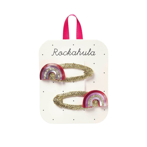 Packaged hair accessories with rainbow design on branded card.