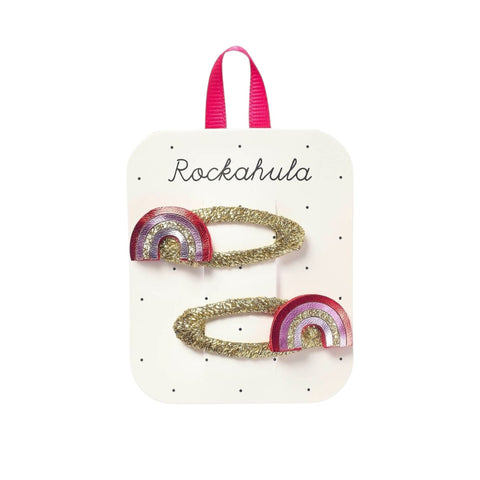 Packaged hair accessories with rainbow design on branded card.