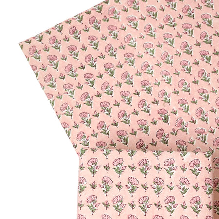 Floral patterned gift wrap with pink flowers on a light pink background
