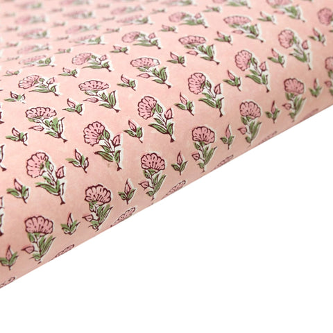 Floral patterned gift wrap with pink flowers on a light pink background