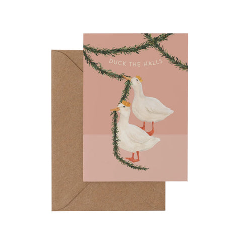 Greeting card with two ducks and a branch, featuring 'Duck the Halls' text, with a brown envelope.