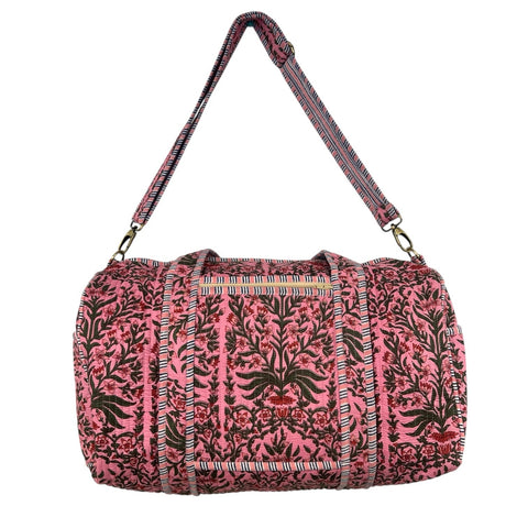 Pink and green floral patterned duffel bag with a strap on a white background