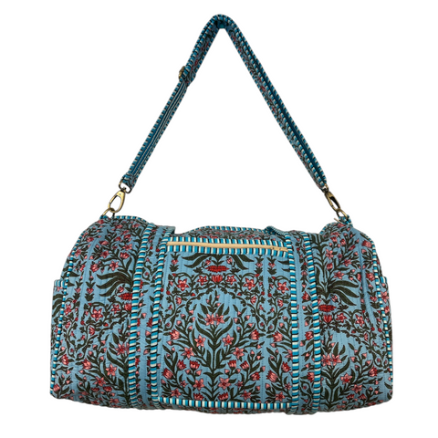Floral blue patterned duffle bag with a blue strap on a white background