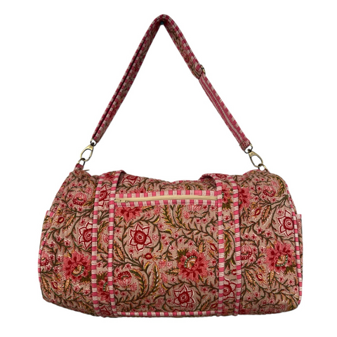 Floral patterned duffel bag with a strap on a white background