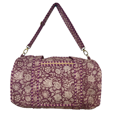 Purple floral patterned duffel bag with a matching strap on a white background