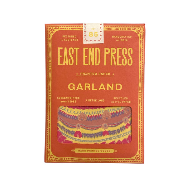 printed pink package with East End Press on the front, inside is a party cake garland.
