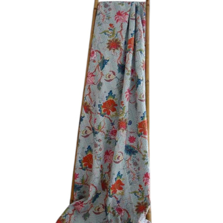 Floral patterned fabric draped over a wooden rod on a white background