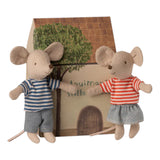 two fabric mice wearing stripy t-shirts , stood in front of their cardboard house