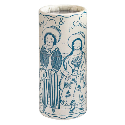 A tall cylindrical tube with a white base and blue hand-painted illustration of two people standing side by side, with the words 'Boy & Sweet' written above them.