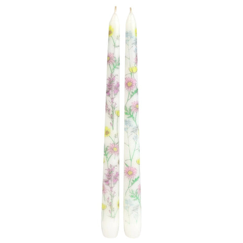 Two floral-patterned candles on a white background