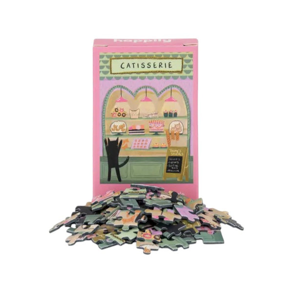 Puzzle packaging with illustrations of a cat and a catisserie, featuring a pink border.