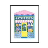 A framed art print featuring a colorful illustration of a French patisserie shop with a pink and white striped awning, blue patterned facade, yellow door, and various illustrated pastries. The print is presented on a white background inside a thin black frame.