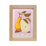 A framed art print featuring an autumn pear illustration with a whole and halved pear on a light pink background, enclosed in a natural wood frame.