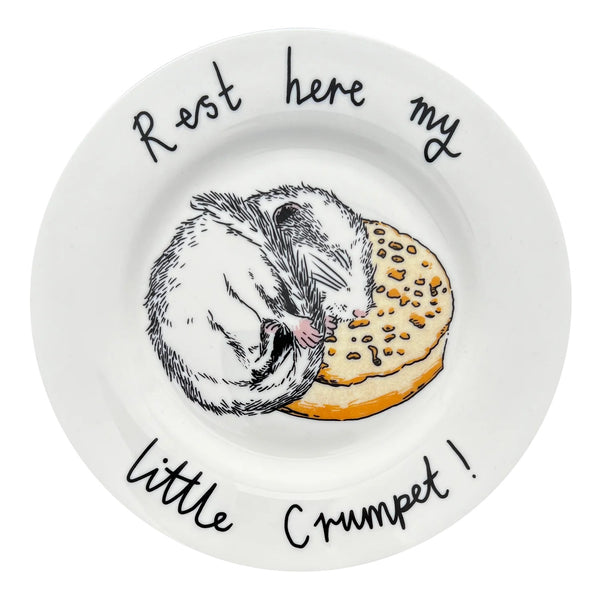 Round white plate with a dormouse illustration and text on a white background