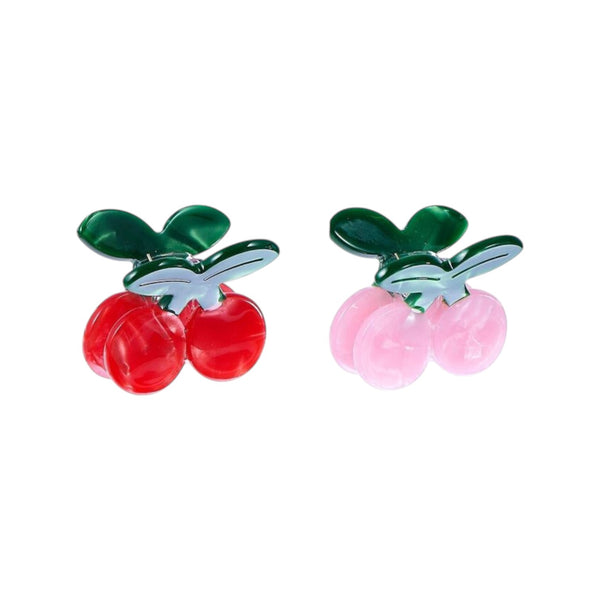 Pair of cherry-shaped clips on a white background