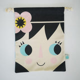 Cotton drwastring bag with little girls face on the front and a harlequin pattern in blue and white on the reverse.