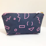Zip case with a teal blue background and pink shapes.