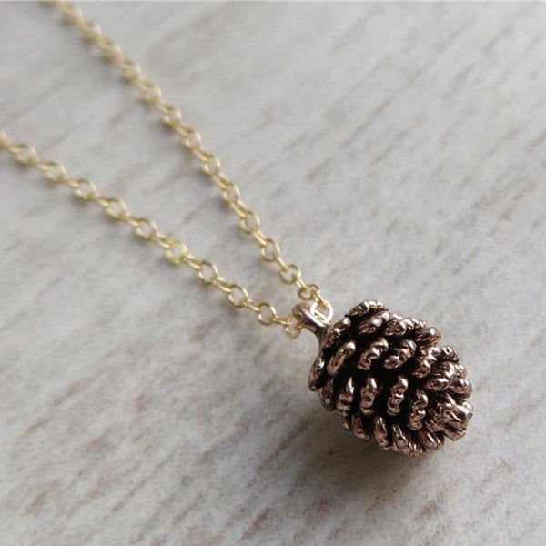 Brass pine cone charm necklace with a gold plated chain.