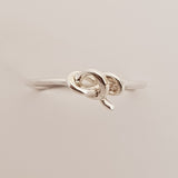 Thin sterling silver wire has been used to make this ring band and tied into a knot to give you the finished style. 