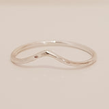 Skinny silver wire hammered ring which has a soft point and textured surface.