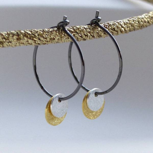 Oxidised silver hoop earrings with gold and silver discs.