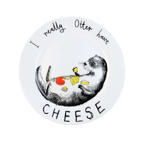 China plate with an otter led on his back eating a selection of cheeses.