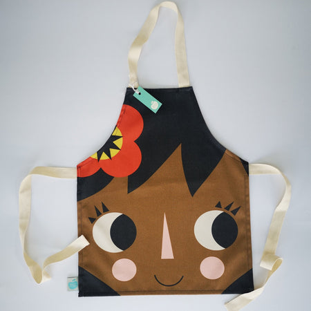 Children's cotton apron featuring a little girl with a red flower in her hair.