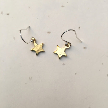 textured brass star earrings with sliver findings.