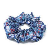 Liberty print cotton hair scrunchie with a blue bird and berry design.