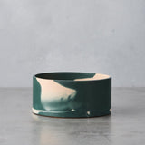 Short round vase in slate green and plaster pink.